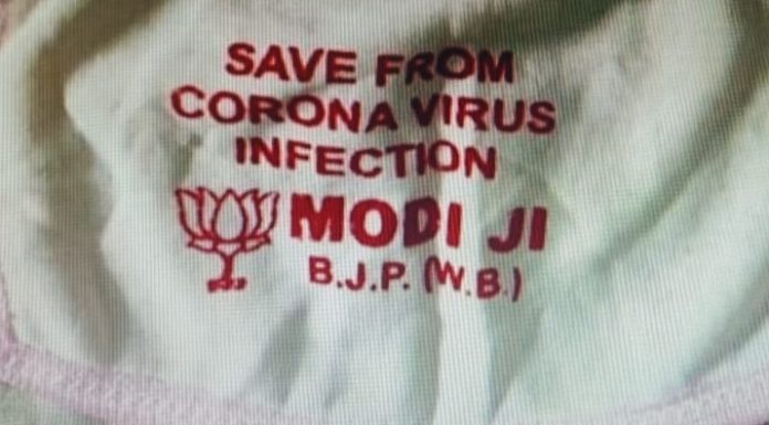 ਕੋਰੋਨਾਵਾਇਰਸ ‘ਤੇ ਸਿਆਸਤ, ਕੋਲਕਾਤਾ ‘ਚ ਵੰਡੇ ਜਾ ਰਹੇ PM MODI ਦਾ ਨਾਂ ਲਿਖੇ ਮਾਸਕ